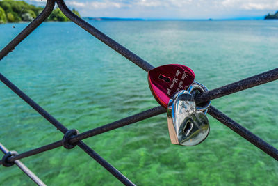 Close-up of padlocks on bridge over river