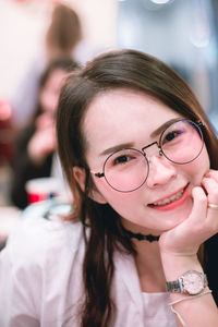 Close-up portrait of young woman at home