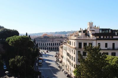 Buildings in city against clear blue sky