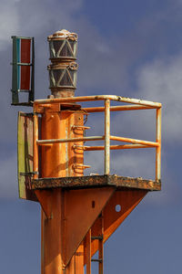 Low angle view of illuminated crane against sky