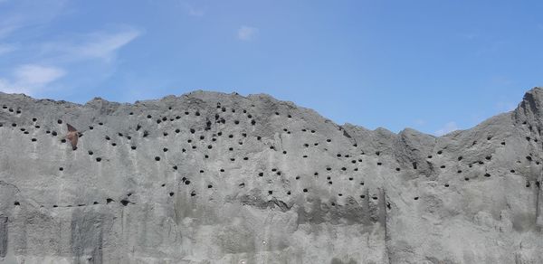 Low angle view of arid landscape against sky