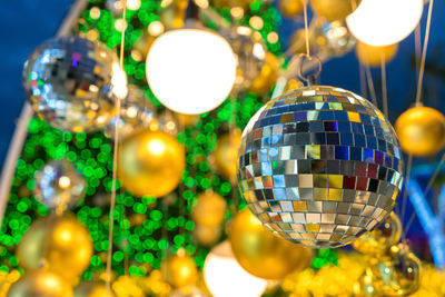 Close-up of silver christmas ornament hanging on tree