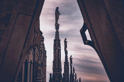 Low angle view of statue of temple against cloudy sky