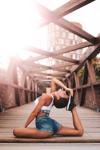 Young woman relaxing on bridge