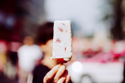 Close-up of hand holding ice cream