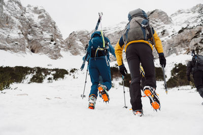 People skiing on snow covered mountain