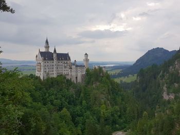 Trees and castle against sky