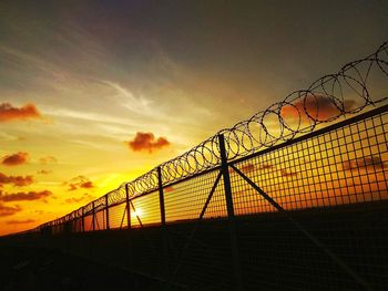 Low angle view of silhouette bridge against sky during sunset