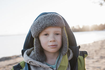 Portrait of boy at the beach at sunset in winter