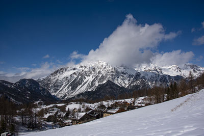 Scenic view of snow covered mountains against sky