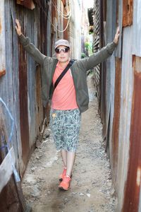 Portrait of woman standing in alley