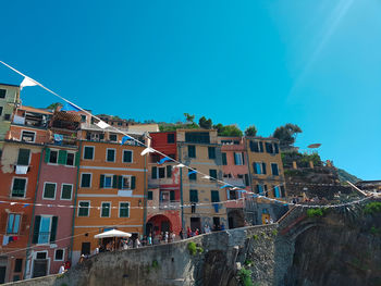 Low angle view of buildings against clear blue sky