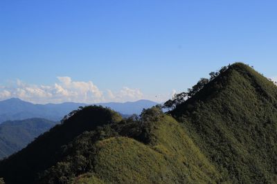 Low angle view of mountains against blue sky