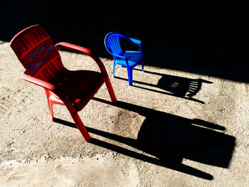 Empty chairs against blue chair