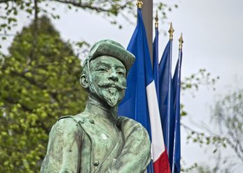 Low angle view of statue against trees