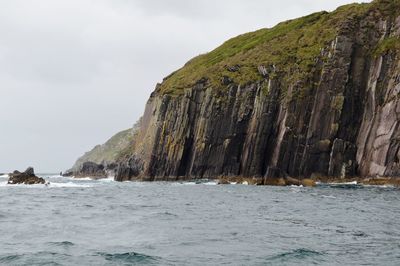 Scenic view of sea and mountains against sky