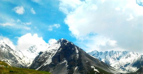 Panoramic view of snowcapped mountain against cloudy sky