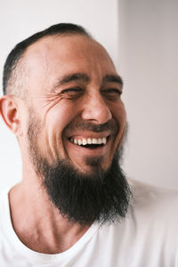 Muslim man with beard is laughing. human emotions.