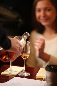 Close-up of woman holding wine glasses