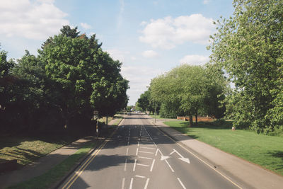 Road amidst trees against sky