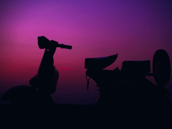 Silhouette man playing with pink sitting against sky during sunset