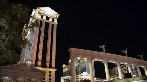 Low angle view of illuminated building against sky at night