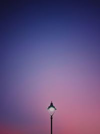 Low angle view of street light at sunset