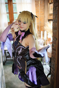Side view of young woman sitting on railing