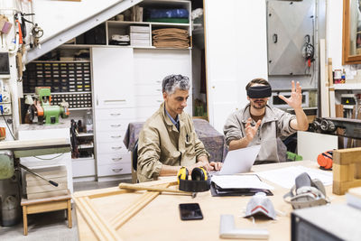 Male carpenter and craftsperson working at workshop