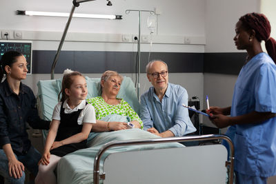 Doctor talking with patient and family