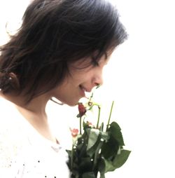 Close-up of woman holding white flower