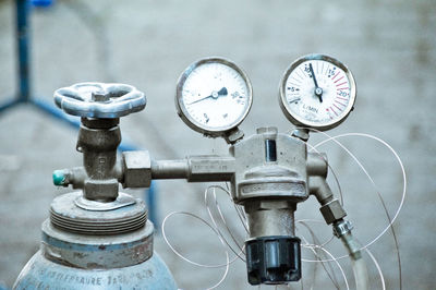 Close-up of pressure gauges attached with cylinder