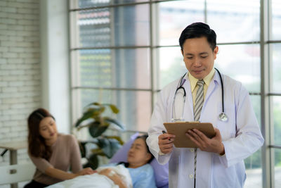 Portrait of young woman using digital tablet