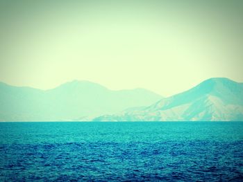 Scenic view of sea with mountains in background