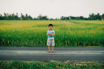 Portrait of boy standing on field