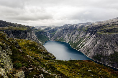 Scenic view of river amidst mountains against sky