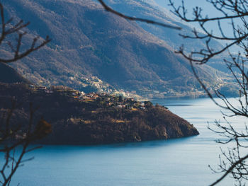 Scenic view of sea and mountains against sky