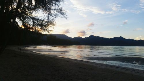 Scenic view of beach against sky during sunset