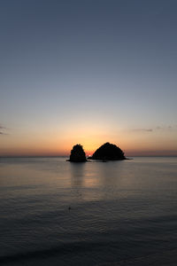 Scenic view of sea against clear sky during sunset