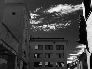 Low angle view of building against cloudy sky