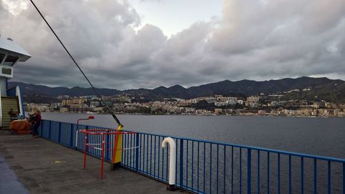 Scenic view of sea by city against sky