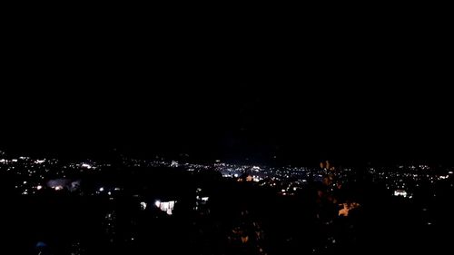 High angle view of illuminated city buildings at night