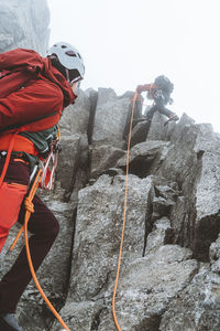 High alpine mountain guide ascending granite ridge near mont blanc