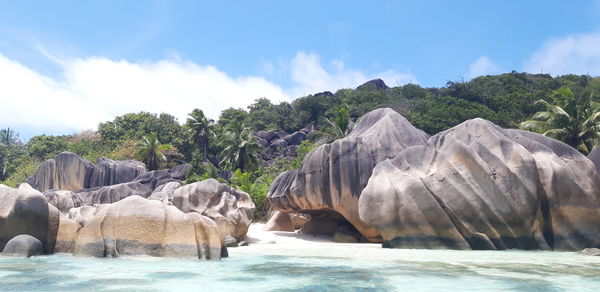 Panoramic shot of rocks in sea against sky