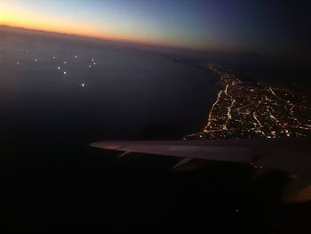 Aerial view of illuminated cityscape against sky at night