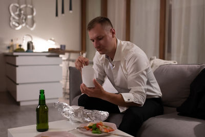 Young man sitting on table