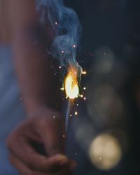 Close-up of hand holding sparkler