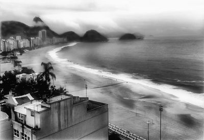 High angle view of buildings by sea against sky