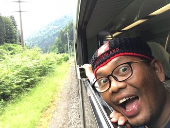 Portrait of a smiling young man in train