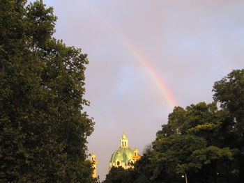 Low angle view of rainbow over trees